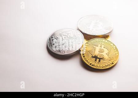 Multiple crypto Bitcoin gold and silver coins photographed on a white background, as a product shooting Stock Photo