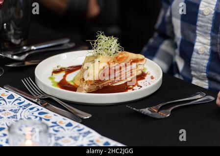 Francesinha, traditional Portuguese sandwich originally from Porto. Served in a restaurant Stock Photo