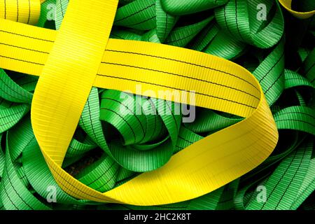 Industrial sewing machine sews a webbing sling. Manufacture of textile slings and tie straps. Stock Photo