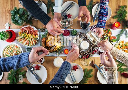 Baked turkey. Christmas dinner. The Christmas table is served with a turkey, decorated with bright tinsel and candles. Fried chicken, table.  Family d Stock Photo