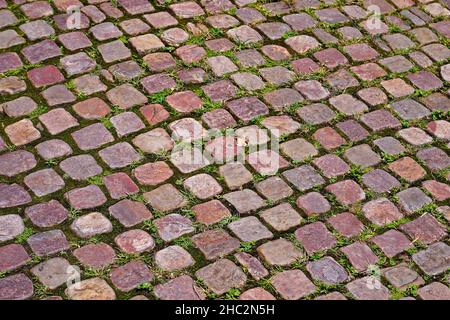 Cobblestone with moss texture background Stock Photo