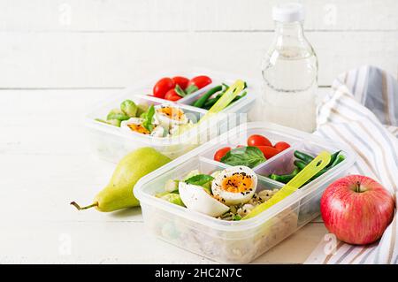 Vegetarian meal prep containers with eggs, brussel sprouts, green beans and tomato. Dinner in lunch box Stock Photo
