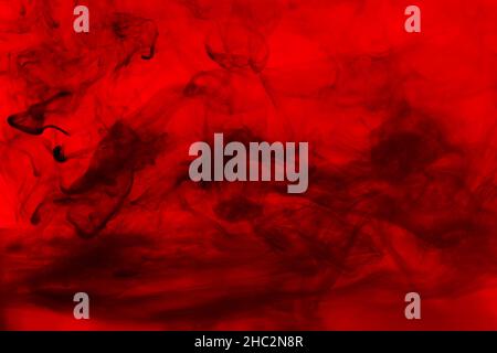 Black abstract smoke on a red background Stock Photo