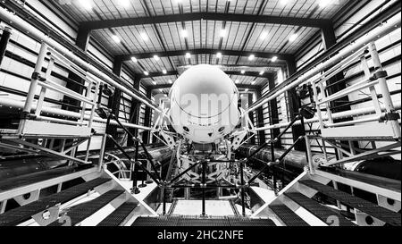 Space launch preparation. Spaceship SpaceX Crew Dragon, atop the Falcon 9 rocket, inside the hangar , just before rollout to the launchpad. Elements o Stock Photo