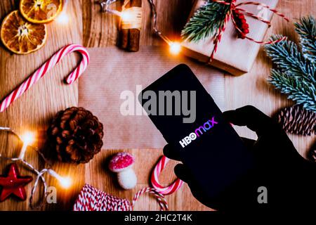 Poland. 21st Dec, 2021. In this photo illustration the HBO Max logo seen displayed on a smartphone and Christmas decorations in the background. Credit: SOPA Images Limited/Alamy Live News Stock Photo