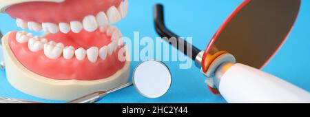 Dental UV lamp for dental jaw filling and instruments on table closeup Stock Photo