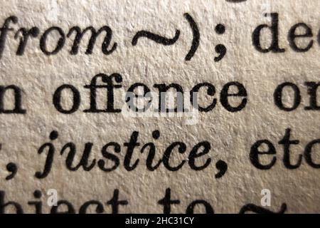 Word "offence" printed on book page, macro close-up Stock Photo