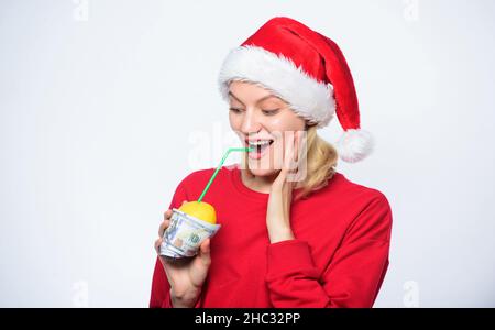 Girl with lemon and money. Lemon money concept. Girl santa hat drink juice lemon wrapped in banknote. Totally natural lemon juice. Fresh lemonade Stock Photo