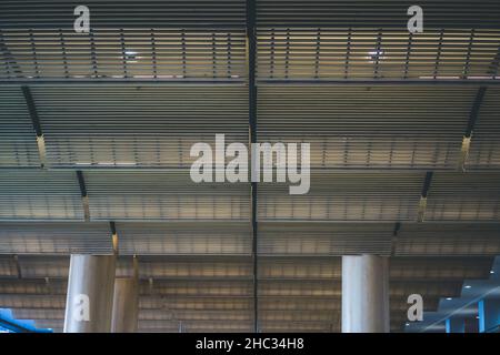 Modern ceiling with geometric lines in a row supported by architectural columns Stock Photo