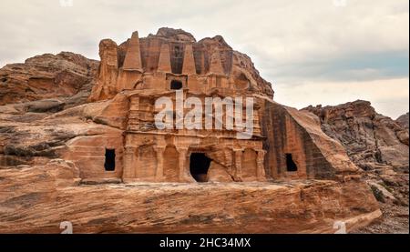 Obelisk tomb and Bab as-Siq Triclinium ruins at Petra, Jordan on overcast morning Stock Photo