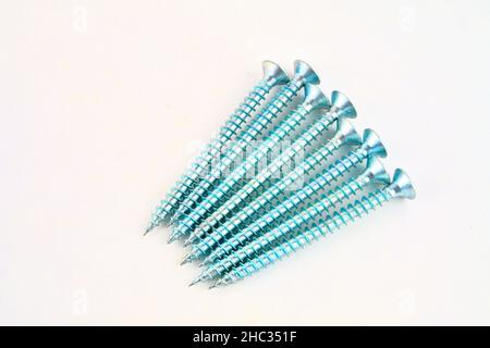 Set of screws for construction on a white background, metal screw, iron screw, chrome screw, screws as a background, wood screw. Close-up. Stock Photo