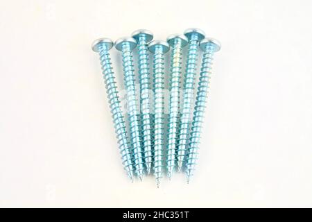 Set of screws for construction on a white background, metal screw, iron screw, chrome screw, screws as a background, wood screw. Close-up. Stock Photo