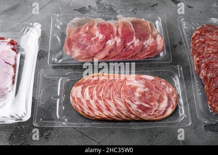 Vacuum packed sausage coppa sliced salami set, on gray stone table background Stock Photo