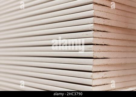 Stack of gypsum boards. Drywall packs. Close-up Stock Photo