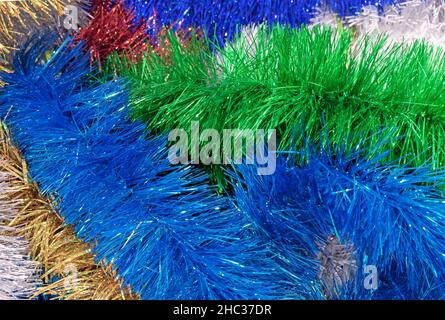Multicolored Christmas tinsel. Tinsel for Christmas decor. Stock Photo
