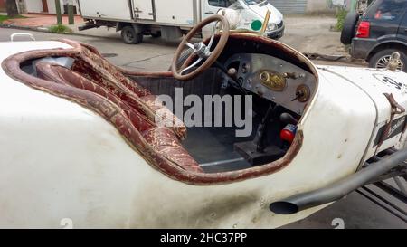 Buenos Aires, Argentina - Nov 7, 2021 - Cabin interior of a vintage Overland 1919 speedster baquet for racing. Dashboard, steering wheel, gear stick, Stock Photo