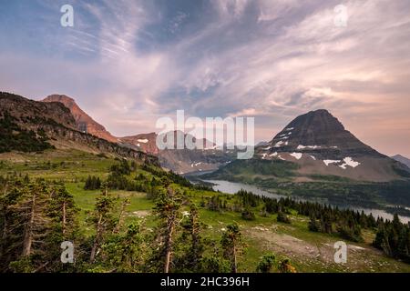 Travel portrait of man wearing hoodie with face hidden looking towards the  mountains Stock Photo - Alamy