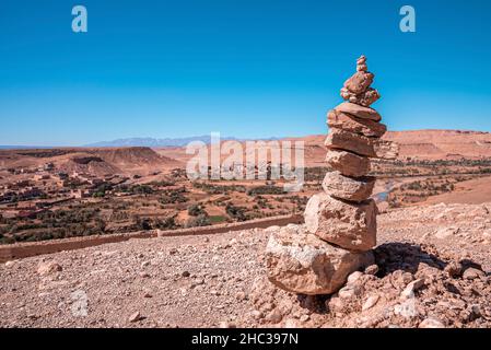 Stack of stones or rocks on mountain landscape against sky Stock Photo