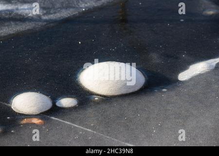 Frozen air bubbles on ice Stock Photo