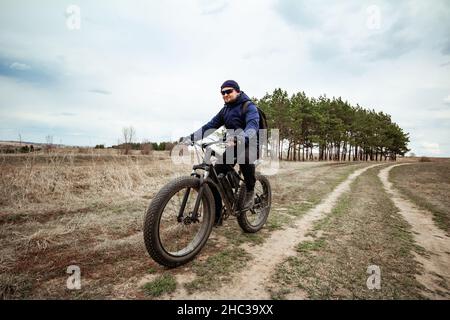 Fat man rides a bicycle on city streets. Intentional motion blur Stock Photo Alamy