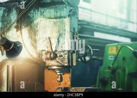 Big retro drilling machine in factory workshop close up. Stock Photo