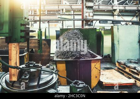 Metal shavings scrap metal waste in steel container in metallurgical factory.