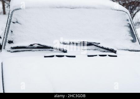 Car windshield wipers and windscreen in snow, closeup Stock Photo