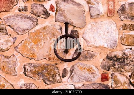 Rusty Ring on Stone Wall on Ranch in Tuscany Countryside Ranch Stock Photo