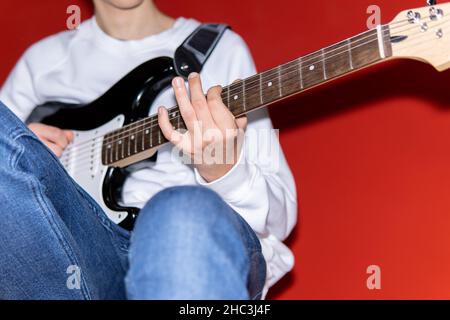 Young man playing electric guitar. Music, instrument education, entertainment, rock star, music concert and learning concept Stock Photo