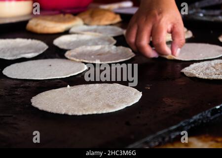 Mexico, Oaxaca, Woman making tortillas outside on traditional comal griddle  Stock Photo - Alamy