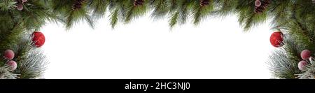 Christmas green pine twigs with red balls and red berries in the foreground. Branches with cones on top framing copy space in the background. Isolated Stock Photo