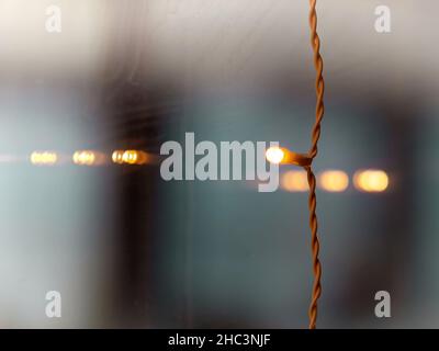 Selective focus photo of a small decoration led light hanging on a window Stock Photo