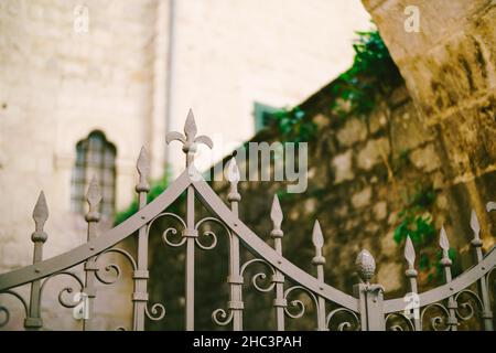 Curly metal tops on an old wrought-iron fence Stock Photo