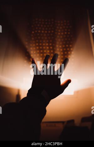 Silhouette of a male hand against sunlight coming from the window Stock Photo