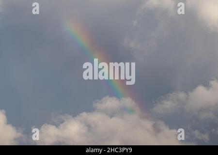 Beautiful view of a rainbow and gray sky on cloudy day Stock Photo