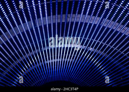 Led neon light tunnel blue color. Curve carbon fiber on the black shadow. background with copy space for design and texture. Stock Photo