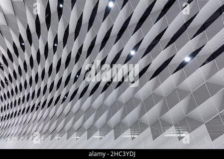 Modern white ceiling viewed from below. Modern and futuristic architecture. Abstract full frame background. Stock Photo