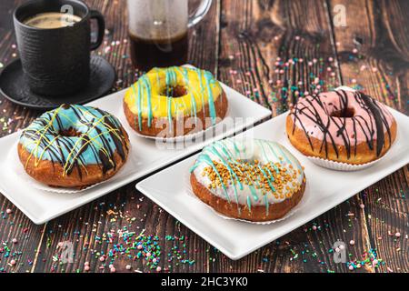 Delicious donuts decorated with different decorations on wooden table Stock Photo