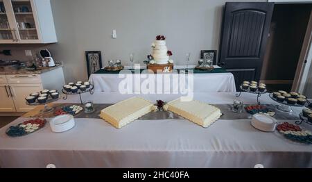 Fourchette table setting with wedding cakes and cupcakes ready for the event Stock Photo