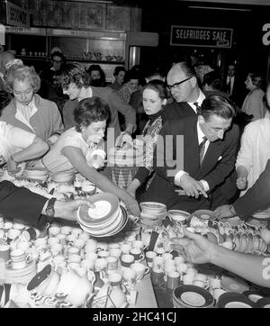 File photo dated 25/6/1964 of shoppers in the China department of Selfridges store in Oxford Street, London, on the first day of the store's June sale. The Weston family has sold the luxury retail group Selfridges, founded in 1908 by Harry Gordon Selfridge, to retailer Signa Holding and property company Central Group. Issue date: Friday December 24, 2021. Stock Photo