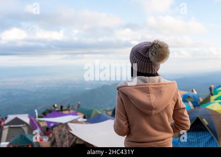 Backside young woman on holiday freedom standing on the mountain Phu Thap Boek Phetchabun, Thailand. Stock Photo