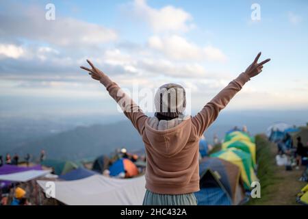 Happy young woman on holiday freedom open hands on the mountain Phu Thap Boek Phetchabun, Thailand. Stock Photo