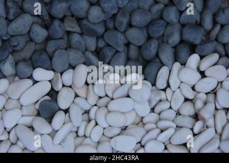 White and grey pebbles in one frame.Great for backgrounds and wallpapers Stock Photo