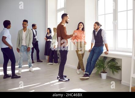 Diverse young people talk at break in company office Stock Photo