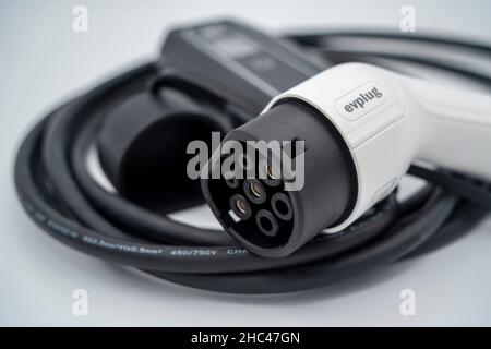 Electric vehicle charging cable - type 2 granny cable charger - cut out isolated on white background Stock Photo