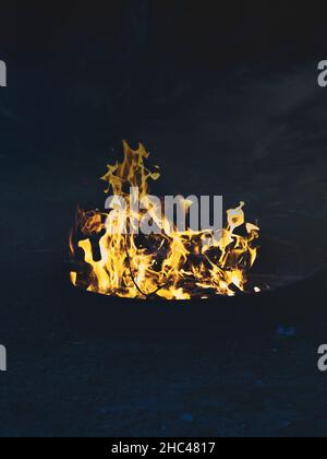 Vertical shot of orange flames at night Stock Photo