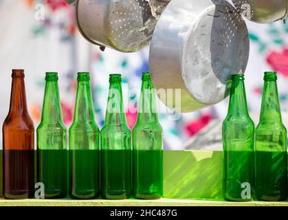 A number of glass bottles and metal dishes. Stock Photo