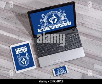 Customer loyalty concept shown on different information technology devices Stock Photo