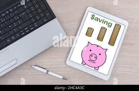 Saving concept shown on a digital tablet Stock Photo