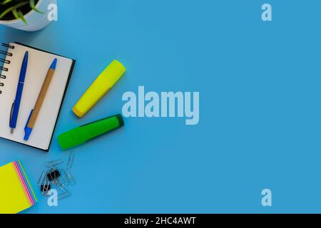 Flat lay workspace, copy space, blue background, top view office desk Stock Photo